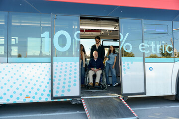 Senior man in wheelchair going down accessible bus ramp © alvaro