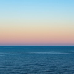 Obraz premium Tranquil ocean expanse at sunset. The deep blue water meets the soft gradient sky precisely along the endless horizon line ,dawn ,twilight ,vacation