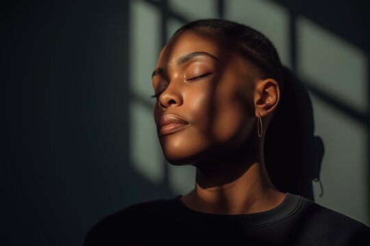 Black Woman with Eyes Closed, Sunlight and Shadow of Bars on Her Face - Powered by Adobe