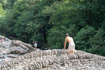 Lavertezzo, Switzerland - August 14, 2025: The charming village in Ticino, Switzerland, is famed for its crystal-clear Verzasca River, where people enjoy a refreshing dip in the cool water.