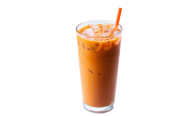 Refreshing glass of thai iced tea with orange straw