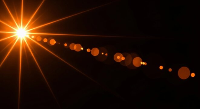 Golden sunburst with lens flare effect on a black background, creating a dramatic and eyecatching visual element for use in graphic design and creative projects