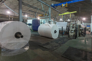 Jumbo rolls in a paper factory workshop.
