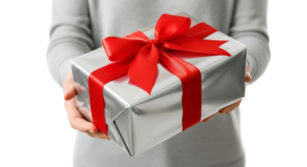 Silver gift box with red ribbon, presented by hands, symbolizing celebration, generosity, and the joy of giving a present