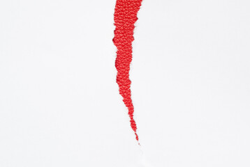 white paper torn in half on a red background