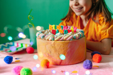 Close-up of girl celebrating birthday sitting at a table