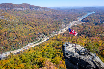Chimney Rock, North Carolina - November 6, 2025: Aerial view of Chimney Rock State Park and Lake Lure amid fall foliage