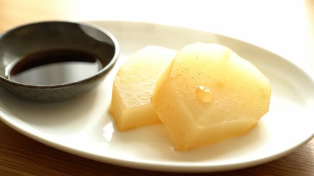 Cooked daikon radish and sauce on a plate, Japanese food