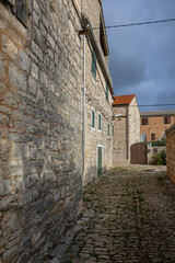 Charming Village Street With Stone Buildings Under Cloudy Sky, Grohote, Croatia