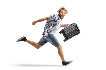 Full length shot of a male tourist running and carrying a suitcase