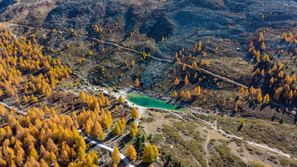 A drone view above Zermatt reveals the stunning Matterhorn region with its famous lakes, golden larches, and a deep blue autumn sky in perfect harmony.