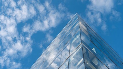 Sleek Glass Facade Mirroring a Bright Blue Sky