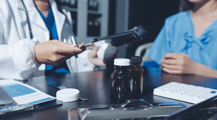 Female doctor holding a medicine bottle is checking the quality of medicine for any side effects the patient or not and recording patient information at the hospital. medical and health care concept