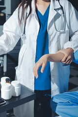 Physical therapist assisting a woman with dumbbell exercise