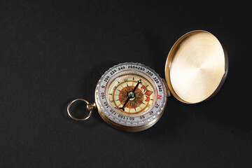 Compass on a black background. Close-up. View from above.
