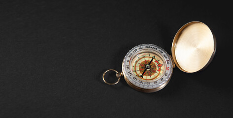 Compass on a black background. Close-up. View from above.