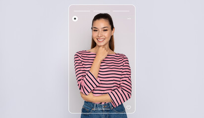A young woman is posing with a playful smile while dressed in a pink and black striped shirt. Her stylish look is highlighted by her confident stance in a simple background.
