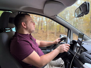 Man driving a van in a forested area