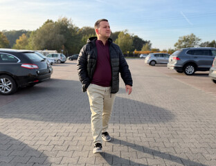 Man walking in a parking lot
