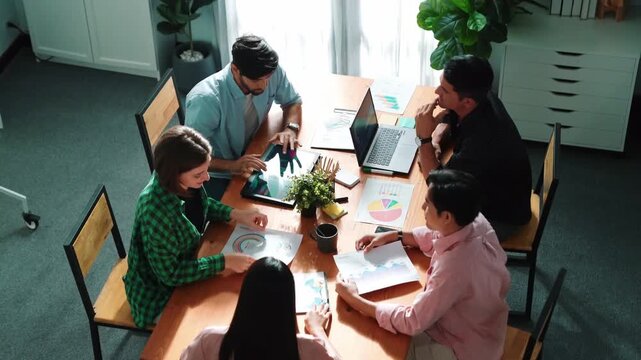 Top view of project manager present financial graph to investors at meeting. Professional marketing team brainstorming financial idea while looking at financial statistic from laptop. Convocation.