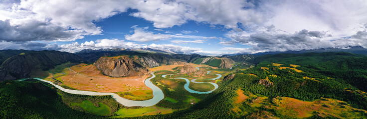 River meander in mountains Altai with yellow autumn trees, aerial top view. Panorama landscape photo from drone