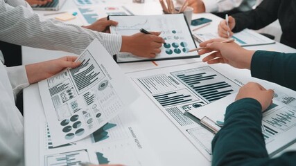 A business team collaborates on financial charts and data reports during a meeting in a modern office, showcasing teamwork and strategic discussions for successful outcomes. SACTR