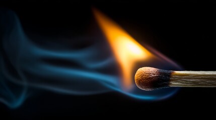 Dramatic close-up of a burning match igniting with vibrant orange flame and wisps of blue smoke against a dark background
