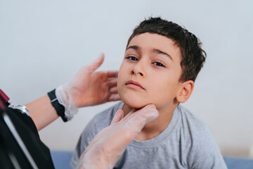 The healthcare worker carefully examines the boy’s face, fostering a sense of calm and trust during a health check.