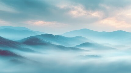 Fototapeta premium Gentle fog blankets the rolling hills as soft light breaks through the clouds at dawn.