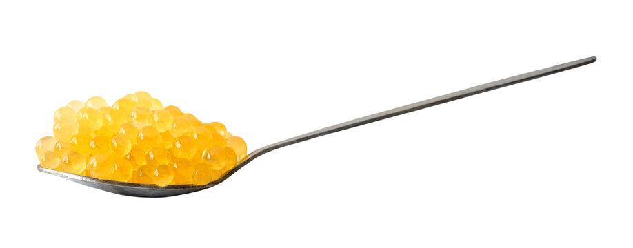side view of trout yellow caviar in spoon cutout