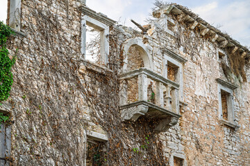 The crumbling ruins of a historic building with balcony in the medieval hill town of Sveti Lovreč, Croatia, in the Istrian region.