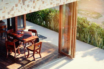 Outdoor Workspace With Laptop and Mug on Wooden Table in Natural Setting