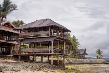 Rustic Beachfront House with Wooden Design and Tropical Surroundings Facing the Ocean