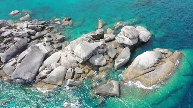 Aerial top view form flying drone of beautiful turquoise blue ocean tropical seascape island for summer vaction on paradise beach.