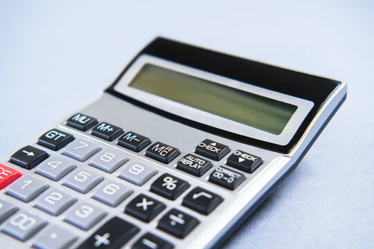Grey calculator on a blue background.