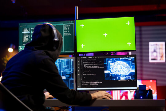 Hacker listening music using mockup PC to launch phishing attacks tricking users into revealing credit card data. Man wearing audio headphones using DDoS attacks to flood servers and crash websites