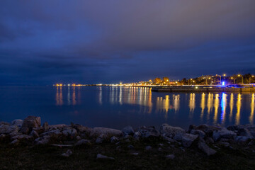 Stunning view of Rimouski's skyline captured at night from Parc Gonzague-Drapeau, showcasing the beautiful reflections on the St. Lawrence River.