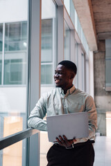 African american business man smiling with laptop