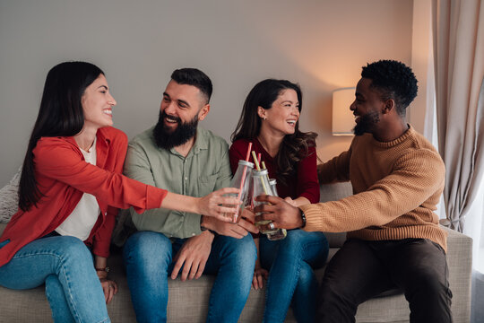 Diverse friends celebrating at home making a toast