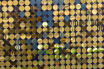 Background from golden sequins in matrix form. Concept of holidays