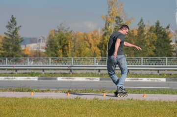 A Caucasian man rollerblades around the slalom course.