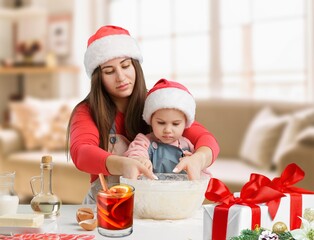 Mother and daughter preparing at kitchen Christmas food