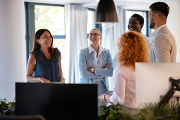 Happy diverse business team enjoying casual office conversation
