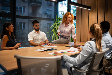 Team brainstorming session with diverse business professionals in modern office