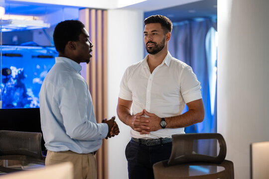 Business professionals engaged in serious office conversation