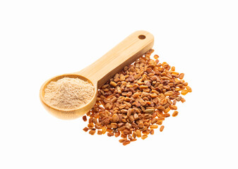 Wooden spoon with fenugreek powder next to the seeds - Methi Dana