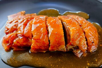 Roasted duck with sauce in plate, indoor Chiangmai Thailand.