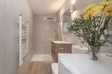Designer shower with a shower panel Natural stone, antique brass faucets, and floating wooden shelves