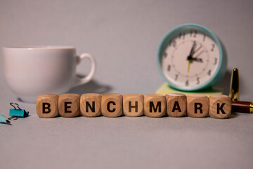 benchmark word on cubes on wooden background.