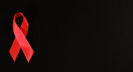 red ribbon symbol of World AIDS Day. Top view. Free copy space.